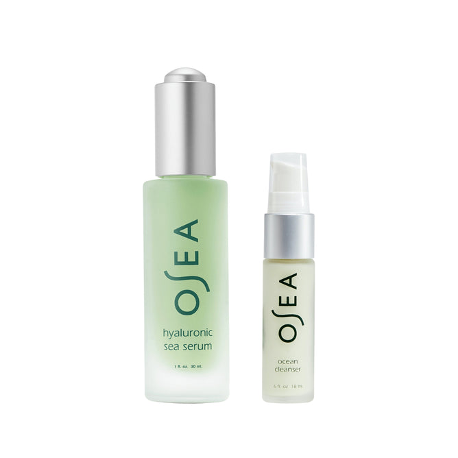 Two minimalist OSEA skincare bottles: a green dropper bottle labeled Hyaluronic Acid Sea Serum + free gift and a smaller pump bottle labeled Ocean Cleanser.