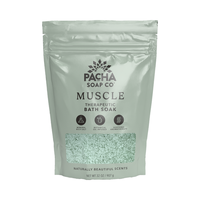 A mint green resealable 32 oz (907 g) bag of Pacha Soap Co. Muscle Salt Soak, featuring icons for mineral-rich soak, botanical oil infusion, and soothing aromatherapy—perfect for muscle relaxation.