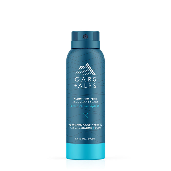 A blue 3.4 fl. oz. Oars + Alps Spray Deodorant in Fresh Ocean Splash scent features a white geometric mountain logo and offers extra-strength, aluminum-free odor defense for underarms and body in a travel-friendly size.