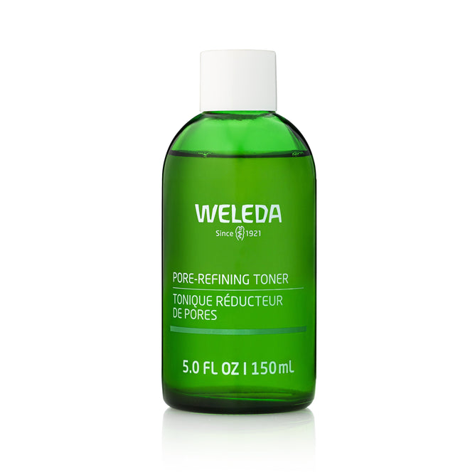 A green bottle of Weleda Pore Refining Toner with sage and witch hazel, labeled in English and French, has a white cap and contains 5.0 fl oz (150 mL).