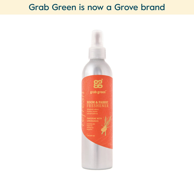 A silver spray bottle of grab green Room and Fabric Freshener - Tangerine with Lemongrass (Coming Soon!) neutralizes odors. Text above reads, grab green is now a Grove brand.