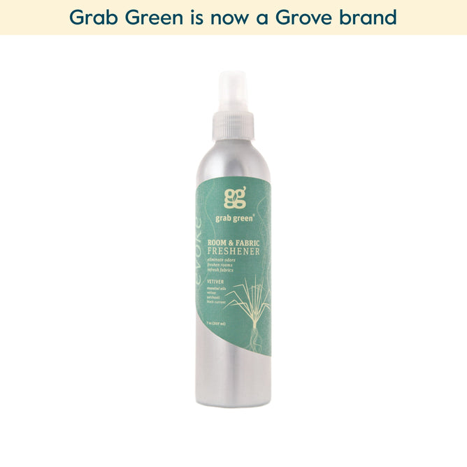 A silver spray bottle of grab green Room and Fabric Freshener - Vetiver (Coming Soon!) sits centered on a white background. Text above reads, grab green is now a Grove brand.