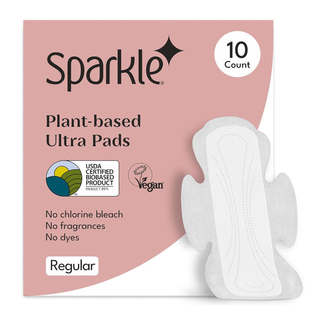 A package of Sparkle Ultra Pads with Wings, 10 count, is displayed with one pad shown. The packaging highlights that the pads are hypoallergenic, vegan, USDA Certified Biobased, and free from chlorine bleach, fragrances, and dyes.