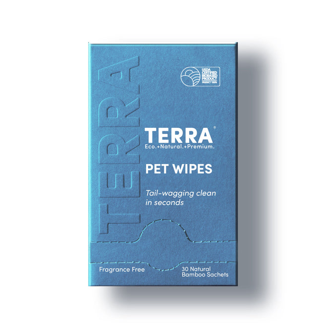 The Terra Pet Grooming Wipes are fragrance free, gentle, hydrating, and individually wrapped. Each blue box contains 30 bamboo wipes for a quick, water-free clean—perfect for pets on the go. Labeled “Eco. Natural. Premium.”.