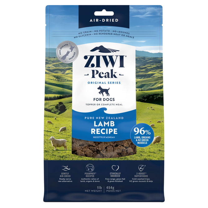 A blue and white bag of ZIWI Air-Dried Dog Food - Lamb, all natural, high protein, grain free with superfoods, shows green New Zealand hills and sheep. The label highlights limited ingredients and air-drying technology.
