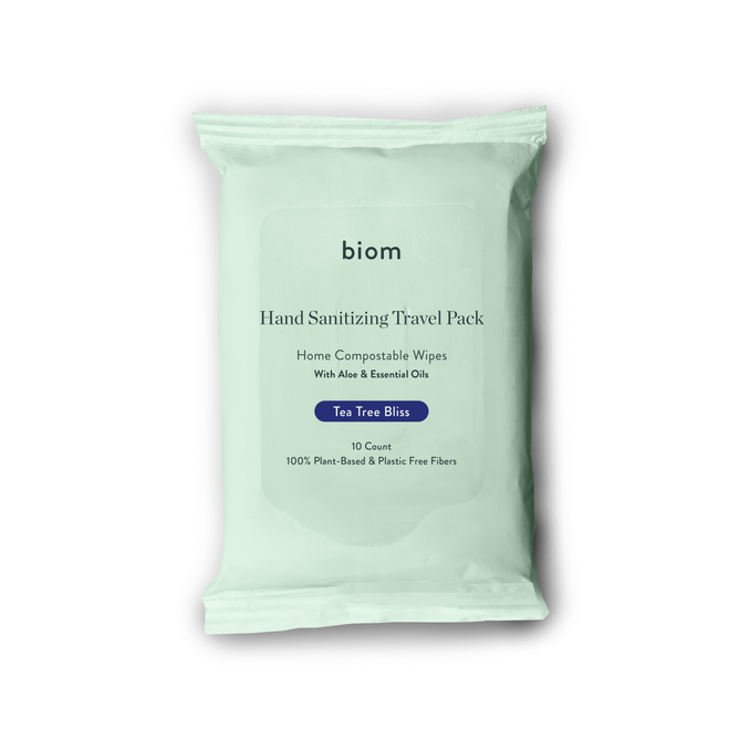 A green Biom Hand Sanitizing Wipes - Travel Pack with a Tea Tree Bliss scent includes 10 home compostable, plant-based wipes made with aloe and essential oils. Its CDC-compliant, 99.9% germ-effective, and plastic-free.