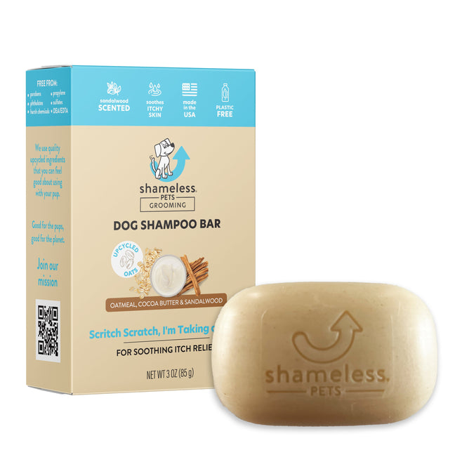 Image of the Scritch Scratch, Im Taking a Bath Shampoo Bar by Shameless Pets. This eco-friendly, light brown bar in a tan box with blue accents features oat & cocoa butter and sandalwood to soothe itchy skin while keeping your pets coat healthy and nourished, free from harmful substances.