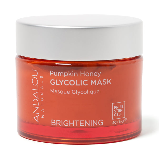 A jar of Andalou Naturals Brightening Pumpkin Honey Glycolic Mask features fruit stem cells. The orange container with a white lid highlights its glycolic AHA and brightening qualities from innovative fruit stem cell science.