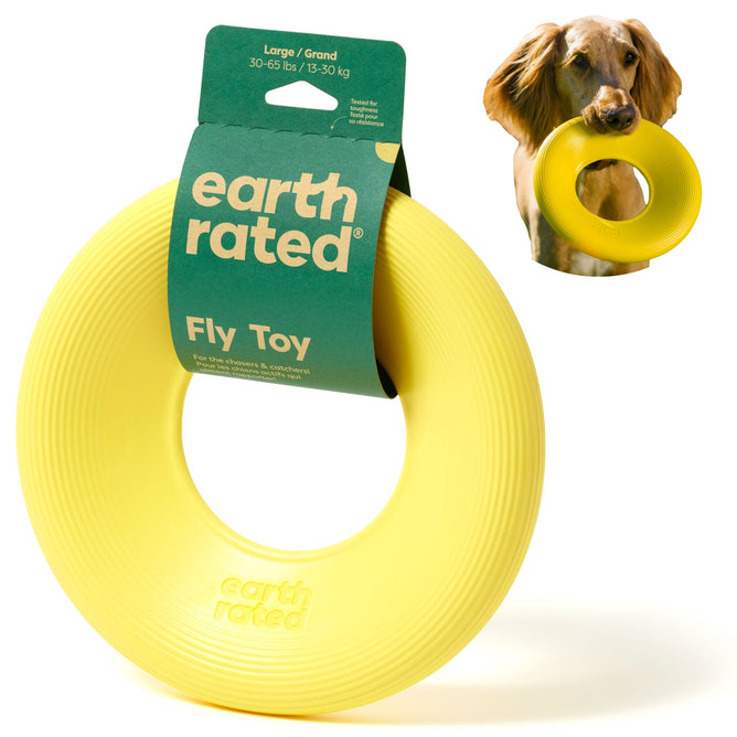 The Earth Rated yellow Flyer Dog Toy, designed for large dogs (30-65 lbs), features Fly Toy branding. Its packaging shows a dog holding the interactive ring-shaped fetch toy in its mouth.