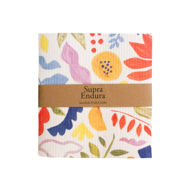 The Supra Endura Swedish Dishcloths feature vibrant floral and leaf patterns in red, blue, yellow, and green. Super absorbent for eco cleaning, they come with a brown paper band labeled Supra Endura Swedish Dish Cloths.