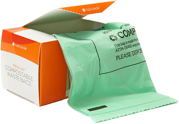 An open box of Full Circle Compostable Food Scrap Bags shows a green bag partially pulled out, with the orange and white packaging indicating theyre ASTM D6400-certified and fresh air compostable.