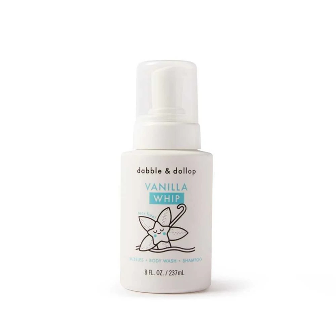 The 8 fl. oz. white bottle of Dabble & Dollop 3-in-1 Whip features a smiling vanilla flower illustration and provides an all-natural, tear-free shampoo, body wash, and bubble bath in one.