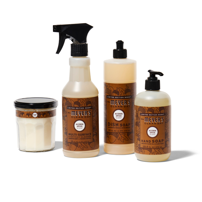 The Mrs. Meyers fall-freshen-up-set-mmcd includes a glass jar candle, multi-surface spray, dish soap, and hand soap in Acorn scent—all with matching brown-accented labels.