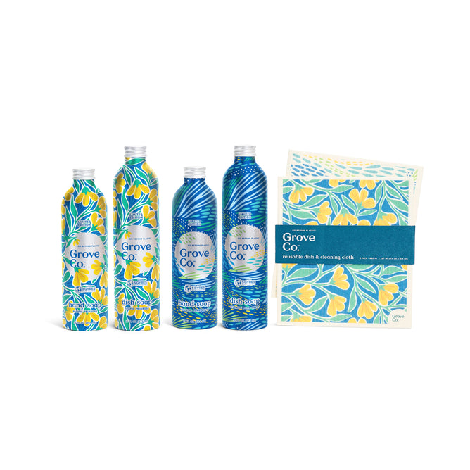 Four Sinkside Essentials - Spring Collection bottles from Grove Collaborative, with floral designs in yellow/blue and blue/white, sit next to reusable dish and cleaning cloths featuring yellow flower patterns, reminiscent of vibrant Pacific Primrose.