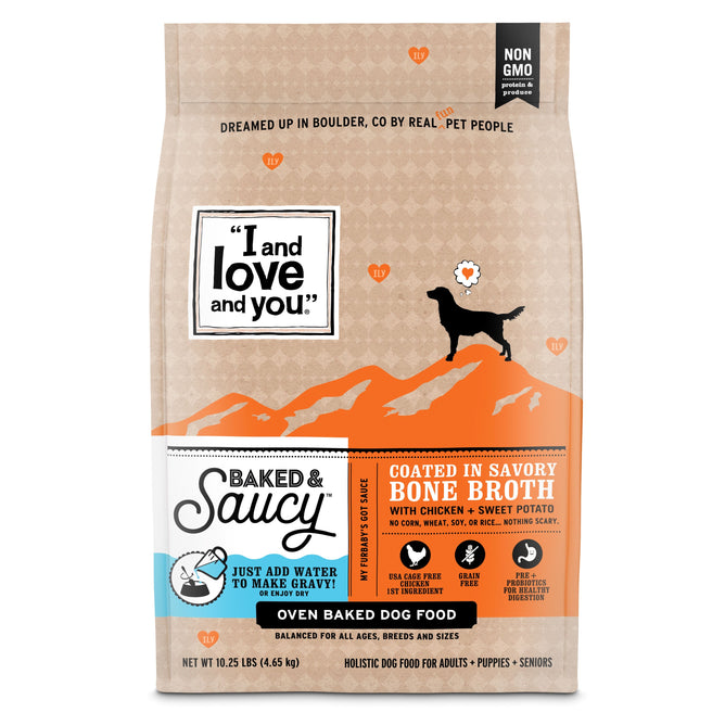 A bag of Baked & Saucy w/ Chicken + Sweet Potato from I and Love and You features a dog silhouette on orange mountains, highlighting its bone broth flavor. Made with USA farm-raised chicken and sweet potato, its non-GMO, holistic, grain-free, and suitable for all life stages.