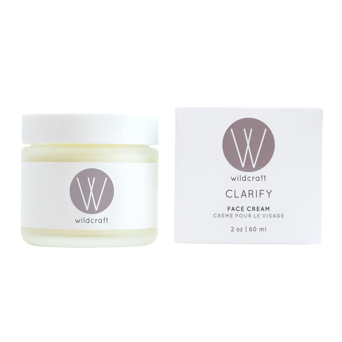 A 2 oz (60 ml) Wildcraft Clarify Face Cream for sensitive skin, adorned with the Wildcraft logo. The white jar has a gray lid, and the box elegantly displays the product name in gray lettering.