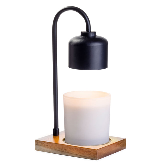 Introducing the Arched Candle Warmer Lamp by Candle Warmers Etc., a modern masterpiece featuring a sleek black metal arc and chic cylindrical metallic shade. It hovers over a glowing white candle on a stylish wood base, blending simplicity and functionality perfectly.