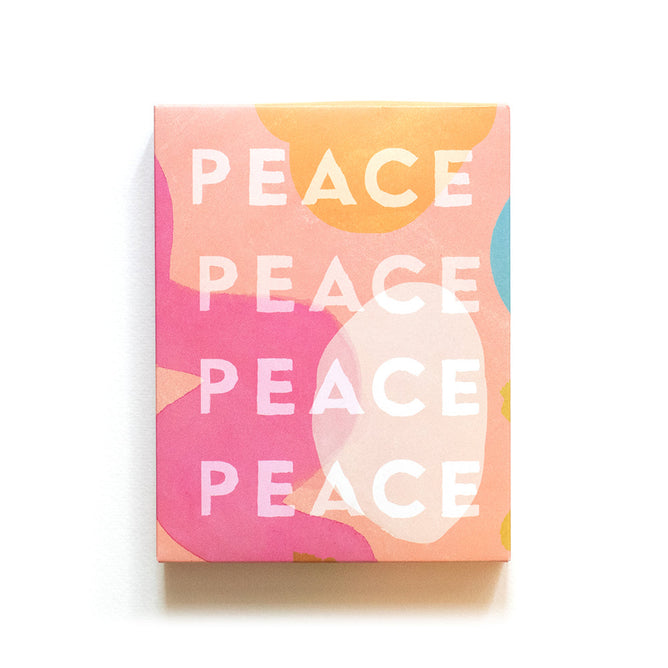 The Holiday Cards - Peace by Supra Endura feature vibrant hand-painted PEACE in bold white, set against a lively swirl of pink, peach, yellow, and blue shapes—ideal for an eco-friendly card set.