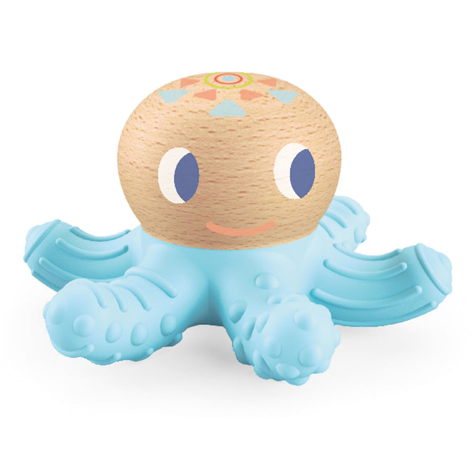 The DJECO BabySquidi Infant Teether, suitable for 0+ months, is an engaging toy made from FSC® Certified Wood. It features an octopus design with a wooden head, a smiling face, and blue eyes. The light blue body has textured legs and colorful geometric patterns on top.