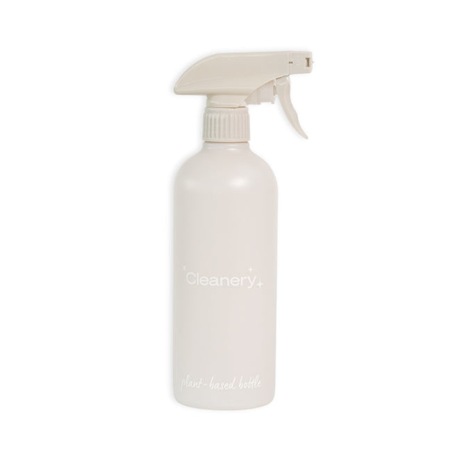 The Cleanery Reusable Cleaning Bottle features a minimalist beige design with a trigger spray nozzle, made from sustainably grown renewable sugarcane for an eco-friendly touch against a plain white background.