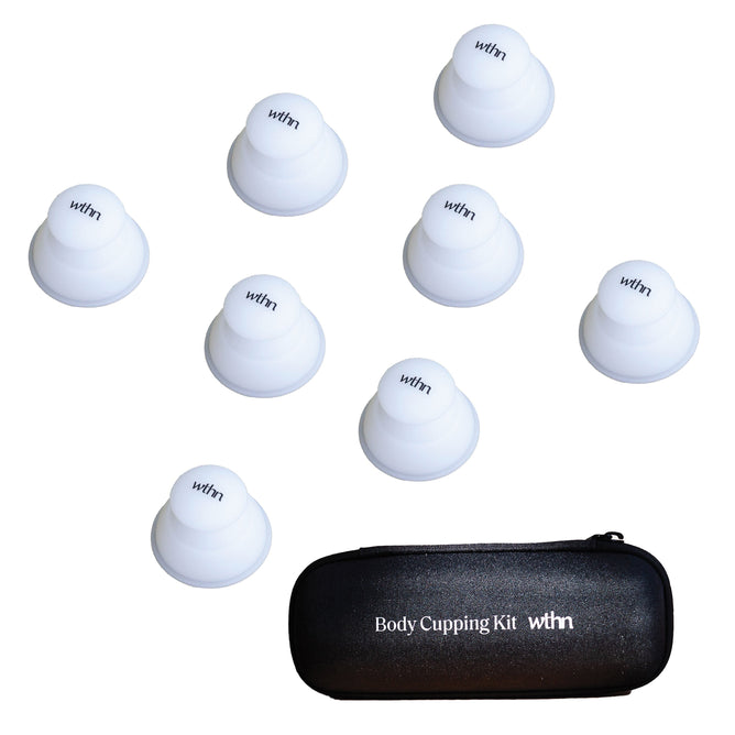 Seven white silicone cups, marked with WTHN, are elegantly arranged around a sleek black carrying case labeled Body Cupping Kit by WTHN. This oval-shaped case embraces Traditional Chinese Medicine principles and is designed to securely hold and transport your cupping essentials.