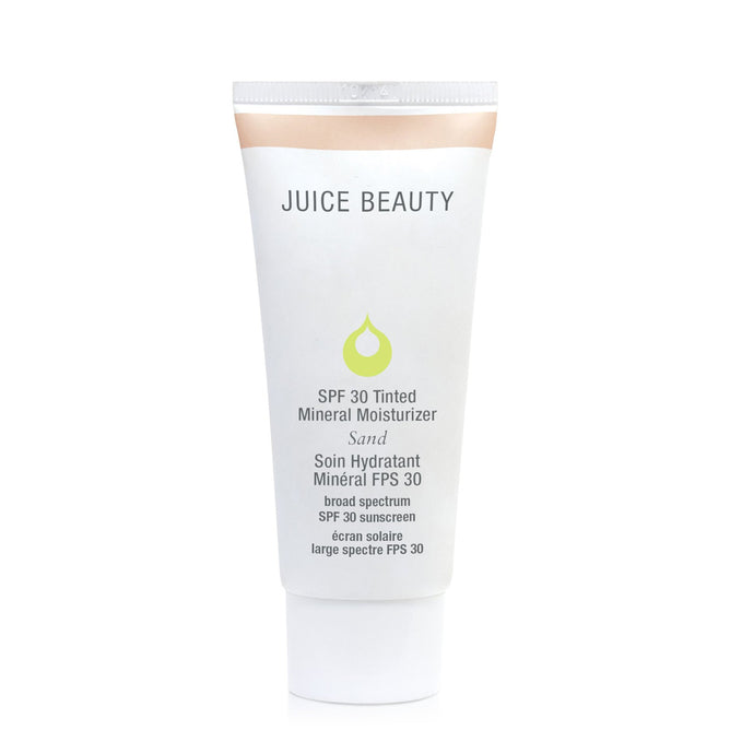 A white tube of Juice Beautys SPF 30 Tinted Mineral Moisturizer in Sand features a green droplet logo. This reef-safe, broad-spectrum BB cream uses mineral ingredients for superior skin protection.