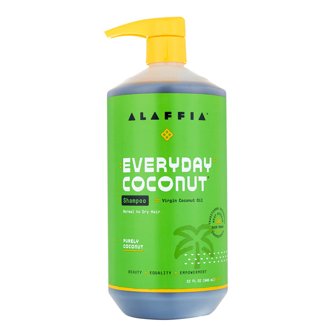 Alaffias Everyday Coconut Shampoo, a 32 fl oz large green bottle with a yellow pump, features virgin coconut oil. Its label has white and yellow text, a coconut tree graphic, promotes ethically sourced ingredients, and is suitable for normal to dry hair.