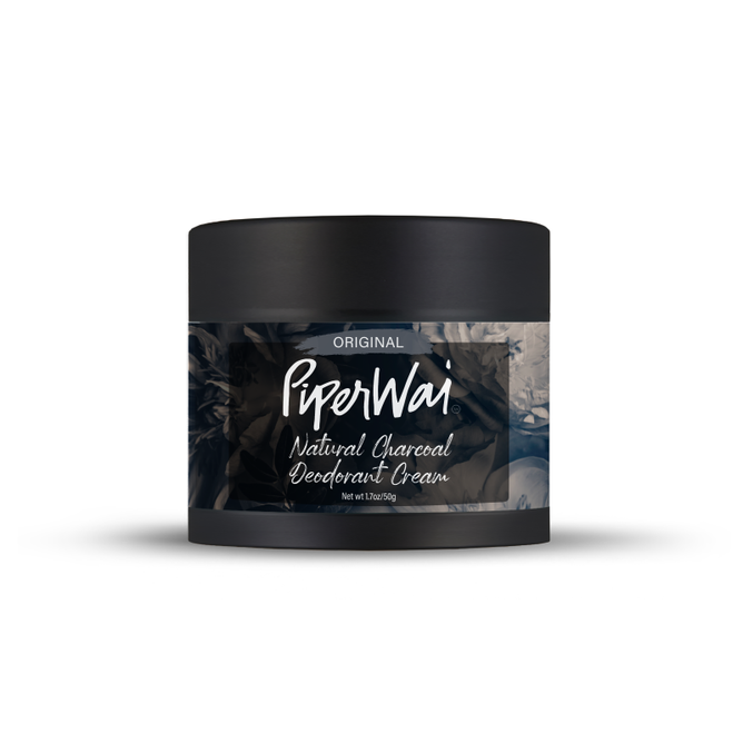 The PiperWai Natural Deodorant Cream features a sleek black container with a smoky design and highlights its original formula. Infused with activated charcoal and skin-conditioning ingredients, it provides a refreshing 2 oz (60g) experience.