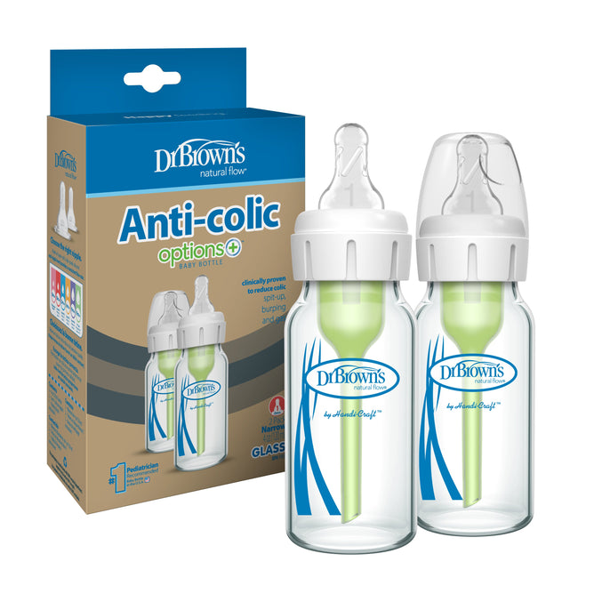 Two Dr. Browns Glass Baby Bottle Natural Flow® Anti-Colic Options+™ with Level 1 Slow Flow Nipples, featuring white caps and green vent systems, are displayed next to packaging highlighting their pediatrician-recommended benefits.