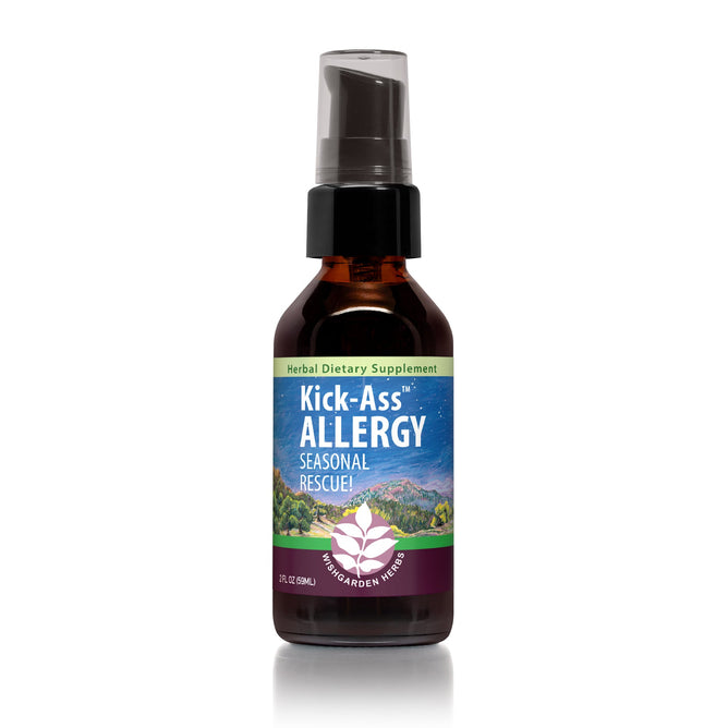 A small brown bottle labeled Kick-Ass Allergy by WishGarden Herbs, featuring a mountain landscape and floral design with a spray nozzle, is crafted to support your bodys immune response against seasonal stressors.