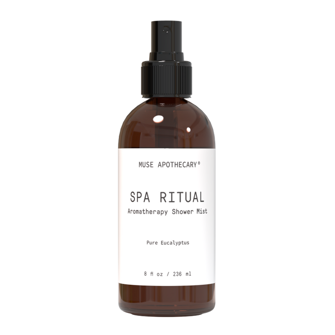 The Aromatherapy Shower Mist by Muse Apothecary, in a brown bottle, offers a luxurious self-care experience with aromatic Eucalyptus oil. It contains 8 fl oz / 236 ml of pure bliss and features a sleek black spray nozzle for easy use.