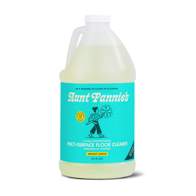 Aunt Fannies Multi-Surface Floor Cleaner, Bulk, features a turquoise label with a vintage illustration and text that reads Ultra-concentrated, powered by vinegar. This hypoallergenic, plant-based cleaner offers a refreshing lemon scent.