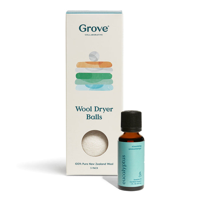 A Wool Dryer Balls + Eucalyptus Essential Oil set by Grove Co. showcases all-natural benefits with a bottle of eucalyptus oil and a box of three hypoallergenic dryer balls, labeled 100% Pure New Zealand Wool, for a gentler laundry experience.