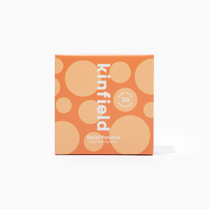 Orange-colored Kinfield Bug Bite Relief Patches box, adorned with beige circles and labeled Bug Bite Remedy, contains 30 patches infused with soothing cajeput oil.