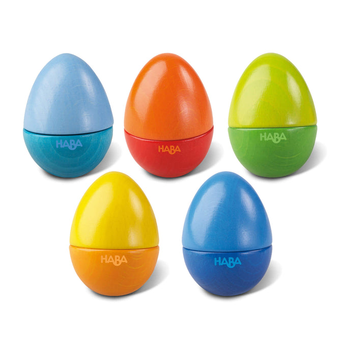 Five HABA Wooden Musical Eggs, two blue, one orange, one yellow, and one green with a shiny finish, are displayed in two rows—three at the back and two at the front.