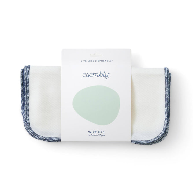 The package of Esembly Babys Reusable Wipes, featuring a pale green circle, displays Wipe Ups and includes 12 certified unbleached 100% organic cotton wipes. These are perfect for sustainable cleaning with their white fabric and blue trim.
