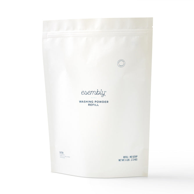 The Esembly Baby Washing Powder Refill Bag is a 4 lbs, all-natural laundry detergent for cloth diapers. It comes in a white resealable package with blue text and minimalist design, intended for use with an eco-friendly refillable canister.