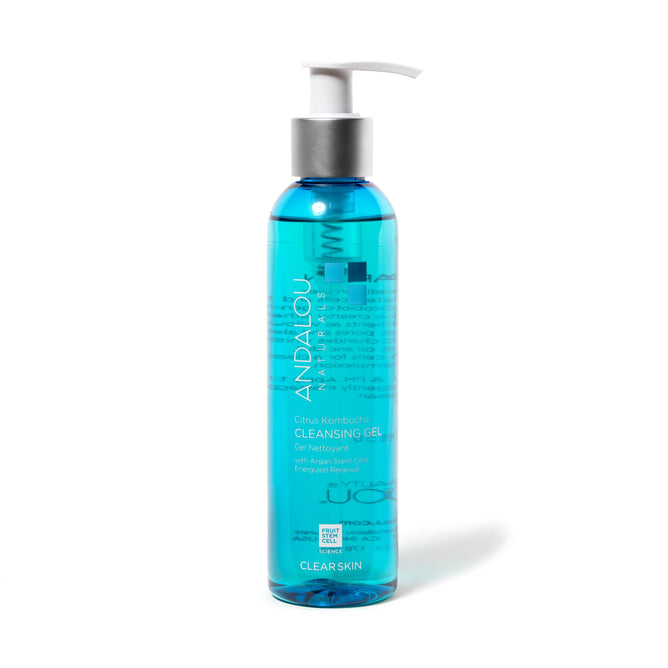 A transparent blue bottle of Andalou Naturals Clear Skin Citrus Kombucha Cleansing Gel with a white pump dispenser features a label highlighting the fruit stem cell complex and ingredients for blemish-prone skin.