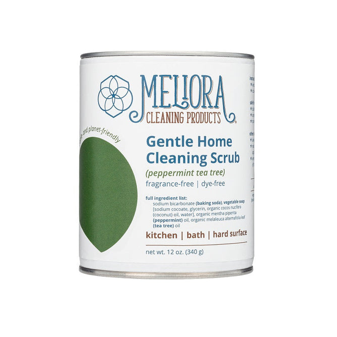 A 12 oz (340 g) cylindrical container of Melioras Gentle Home Cleaning Scrub features a peppermint tea tree scent and is fragrance-free, dye-free, septic-safe, ideal for kitchen, bath, and hard surfaces.