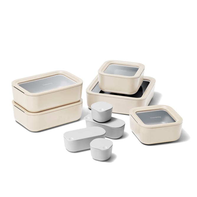The Caraway 17-Piece Food Storage Set, in beige and gray, features rectangular, square, and small cylindrical non-toxic containers with matching lids. Enhanced by Air Release Technology, each piece ensures fresh storage in a neat design.
