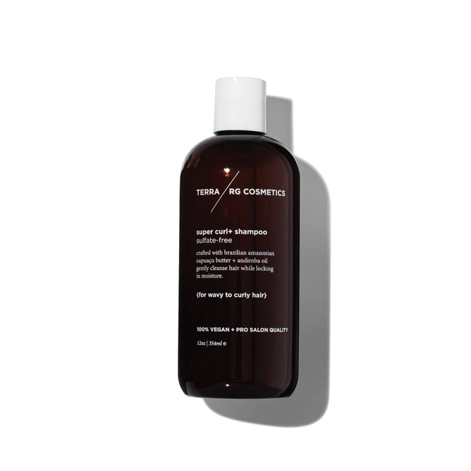 A brown bottle of Terra Beauty Bars Curl+ Shampoo features white text highlighting its sulfate-free and vegan formula, crafted specifically for wavy to curly hair.
