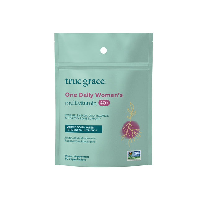 The teal package of True Graces One Daily Womens 40+ Multivitamin Refill with red text highlights immune, energy, and bone support. It features a root illustration and labels for whole food-based nutrients, containing 90 vegan tablets with coenzyme B vitamins and an organic mushroom blend.
