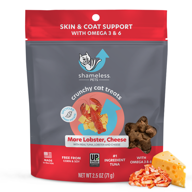 Shameless Pets More Lobster, Cheese Crunchy Cat Treats in red and gray packaging include tuna, lobster, and cheese. These natural treats support skin and coat health with Omega 3 and 6. The package displays images of treats, cheese, and lobster.