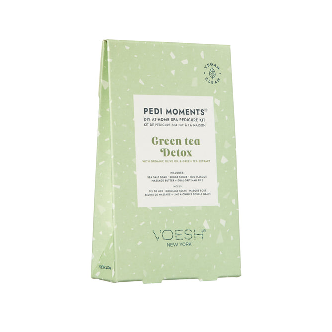 A green rectangular package labeled Pedi Moments from VOESH New York, with green tea detox. Features organic olive and green tea extract for a luxurious at-home spa pedicure. Vegan and clean attributes ensure a true spa experience.