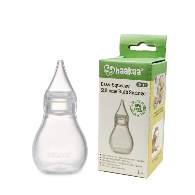 A clear, hypoallergenic Haakaa Silicone Baby Nasal Aspirator is next to its green and white box labeled haakaa Easy-Squeezy. The BPA-free packaging features an image of the aspirator and highlights its suitability for baby airways from 0m+.