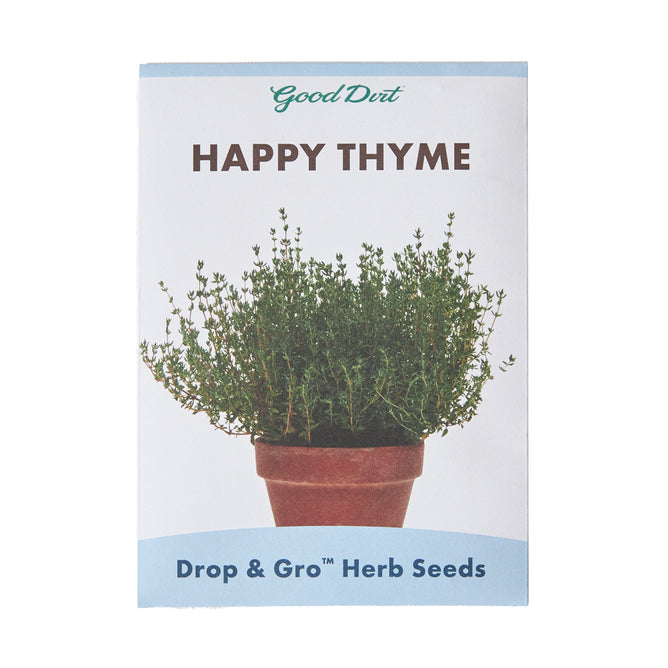 The Seed Pack - Happy Thyme by Good Dirt features a lush thyme plant in a terracotta pot. Certified Non-GMO, this package reads Drop & Gro™ Herb Seeds, perfect for starting your own Happy Thyme Herb Garden.