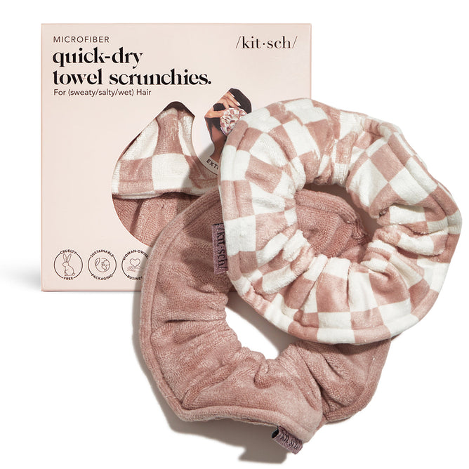 The package includes two pink Kitsch Microfiber Quick-Dry Towel Scrunchies, featuring a checkered and plain designs. The box highlights ultra absorbent and soft microfiber, making them perfect for sweaty, salty, or wet hair post-shower routines.