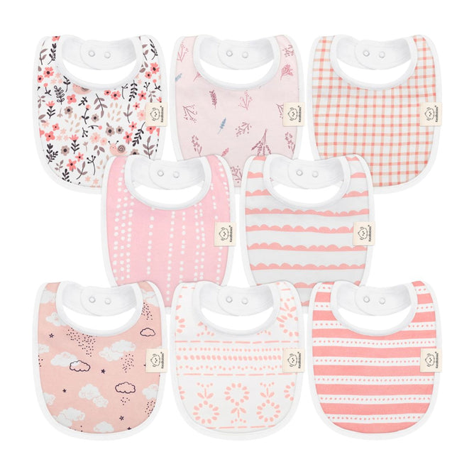 KeaBabies offers an 8-piece set of GOTS Certified, 100% Organic Cotton Baby Drool Bibs. Each bib features a unique design such as florals, plaid, clouds, stripes, and abstract motifs in tones of pink, white, and gray.