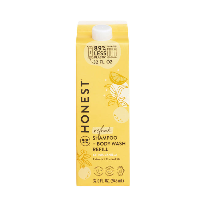 The Honest Companys Shampoo + Body Wash Carton Refill in a yellow carton features a citrus vanilla scent with coconut oil. Its tear-free formula reduces waste by using 89% less plastic and has charming lemon and orange illustrations on the 32 fl oz packaging.