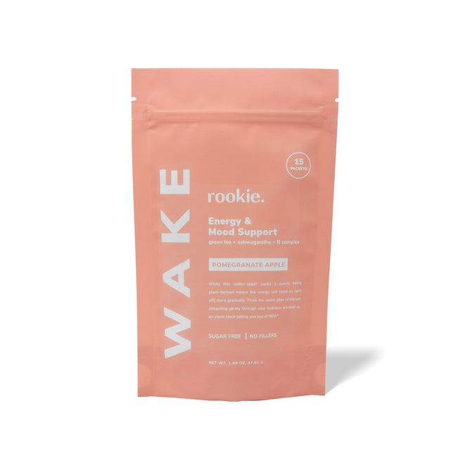 The Rookie Wellness WAKE packet in a coral color offers Energy & Mood Support with adaptogens like green tea and schisandra, plus B-Vitamins, all in a sugar-free pomegranate apple flavor without fillers.